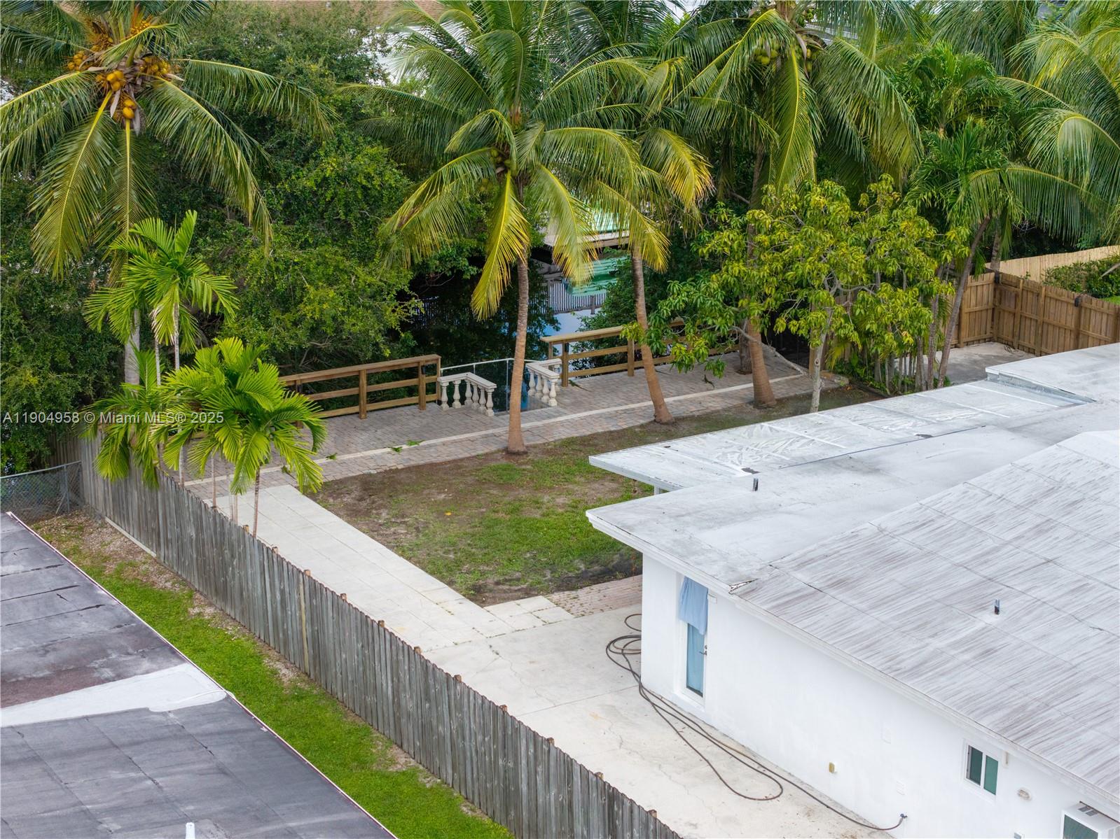 2325 Northeast 194th Street Miami, FL 33180 - Photo 34 of 36 a view of a backyard and swimming pool