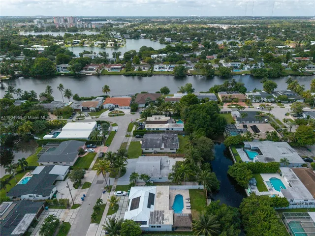 an aerial view of house with yard and lake view