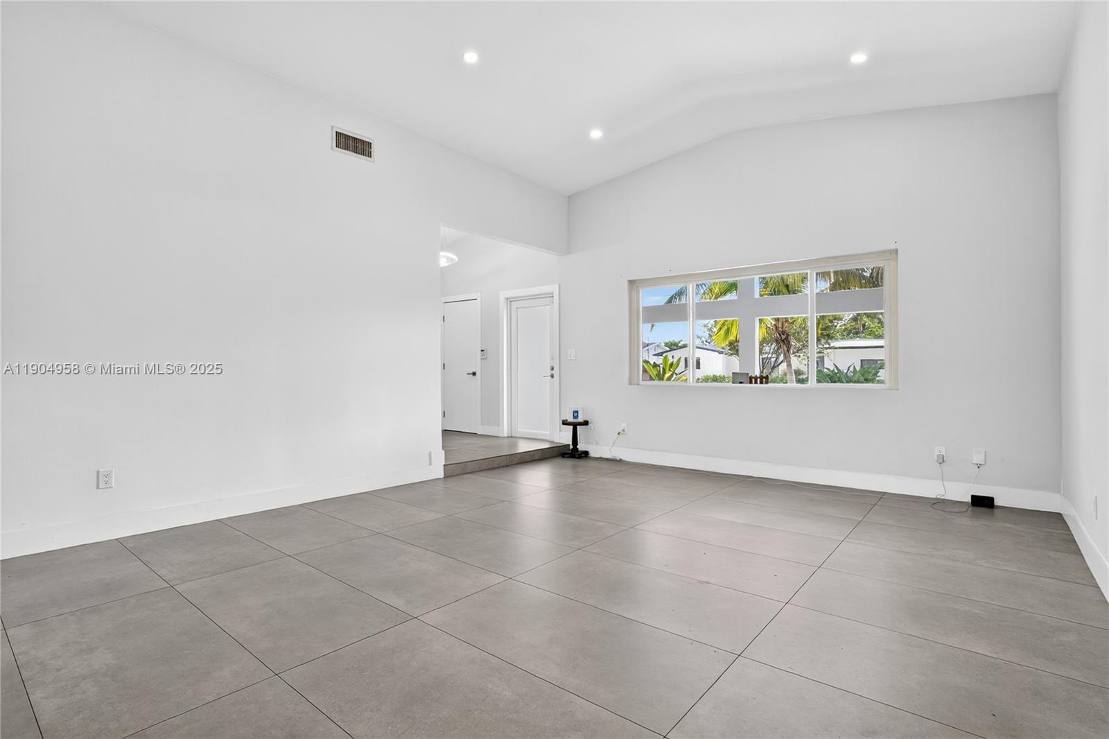 2325 Northeast 194th Street Miami, FL 33180 - Photo 5 of 36 an empty room with windows