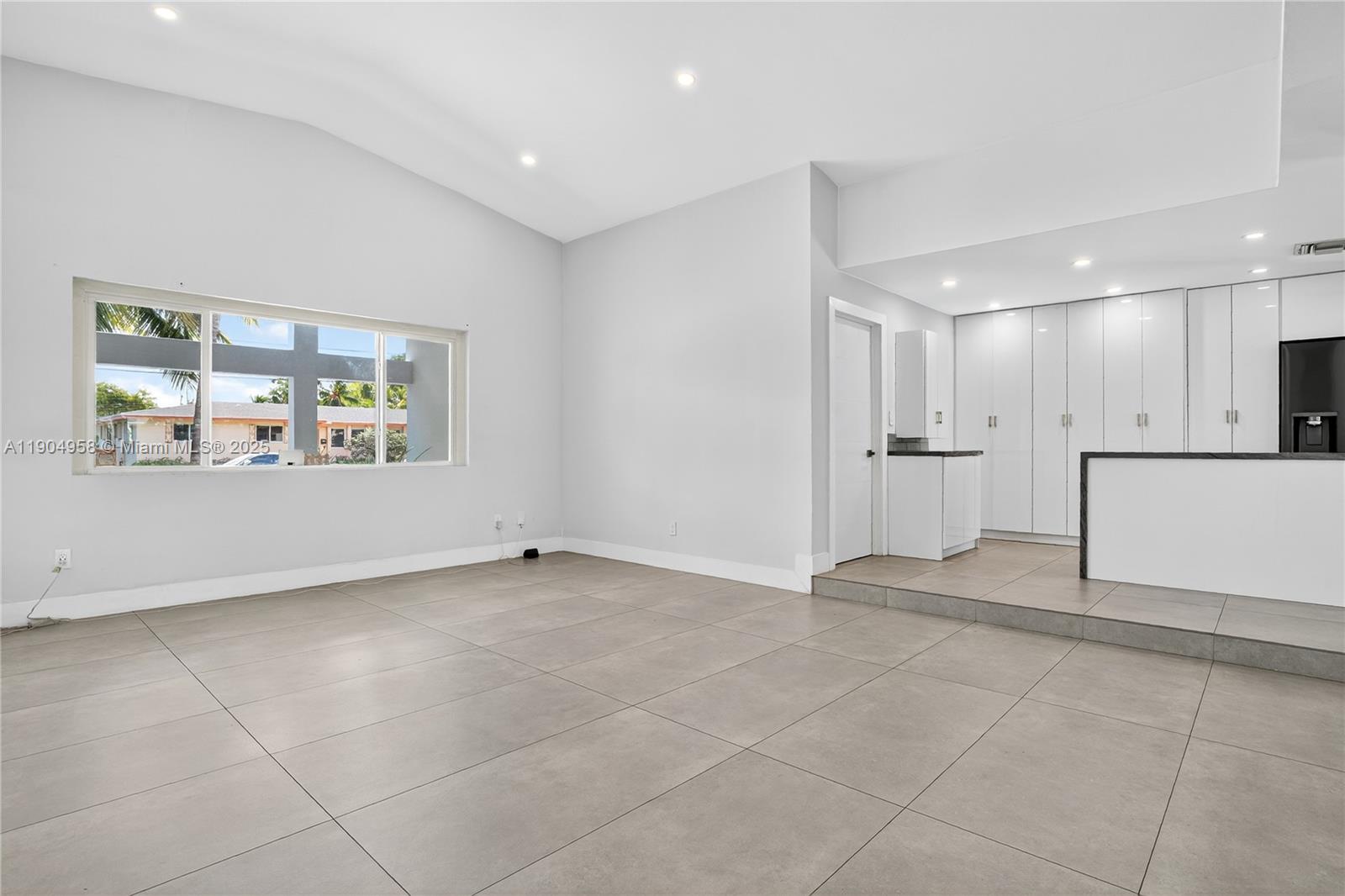 2325 Northeast 194th Street Miami, FL 33180 - Photo 6 of 36 a view of an empty room with a window