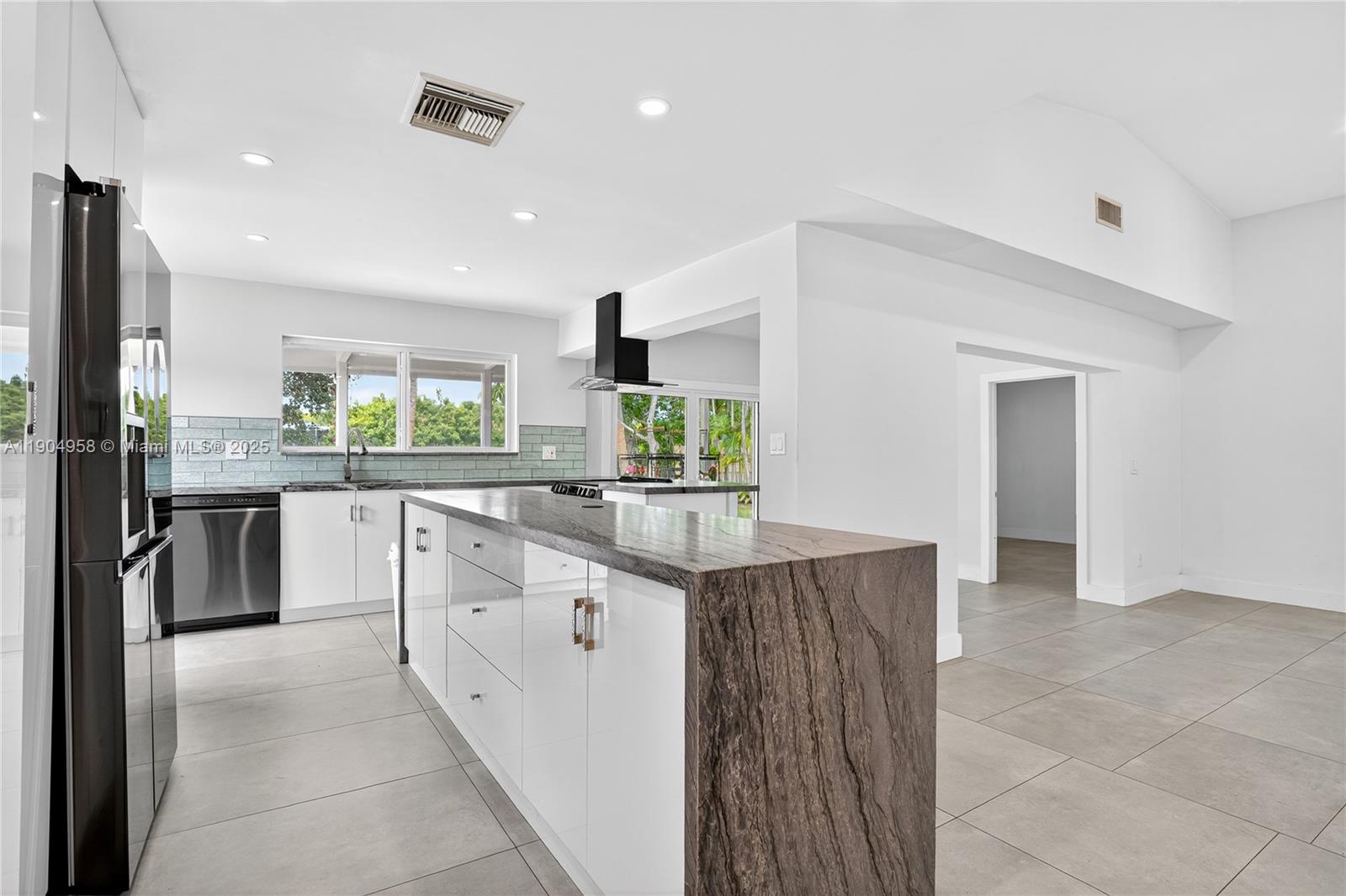 2325 Northeast 194th Street Miami, FL 33180 - Photo 9 of 36 a kitchen with stainless steel appliances granite countertop a sink and cabinets