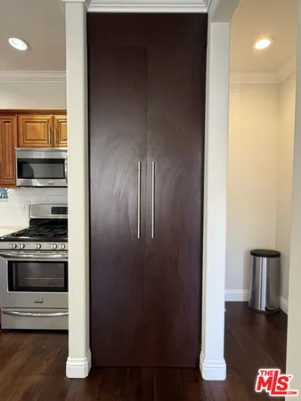 a kitchen with stainless steel appliances granite countertop a refrigerator and a stove