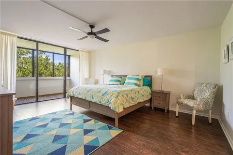 a bedroom with a large bed and a large window