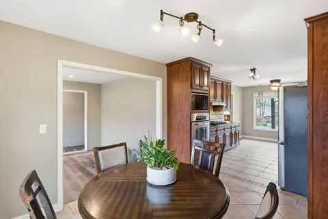 a view of a dining room with furniture wooden floor and a chandelier