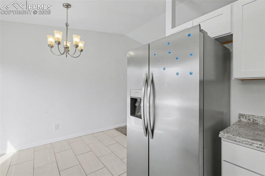 585 Blossom Field Road Fountain, CO 80817 - Photo 13 of 37 a view of a kitchen with granite countertop cabinets and stainless steel appliances