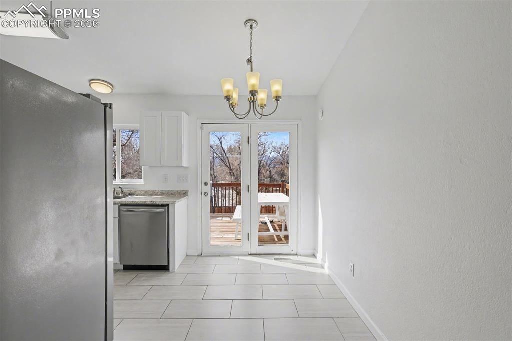 585 Blossom Field Road Fountain, CO 80817 - Photo 14 of 37 a view of an empty room with a kitchen
