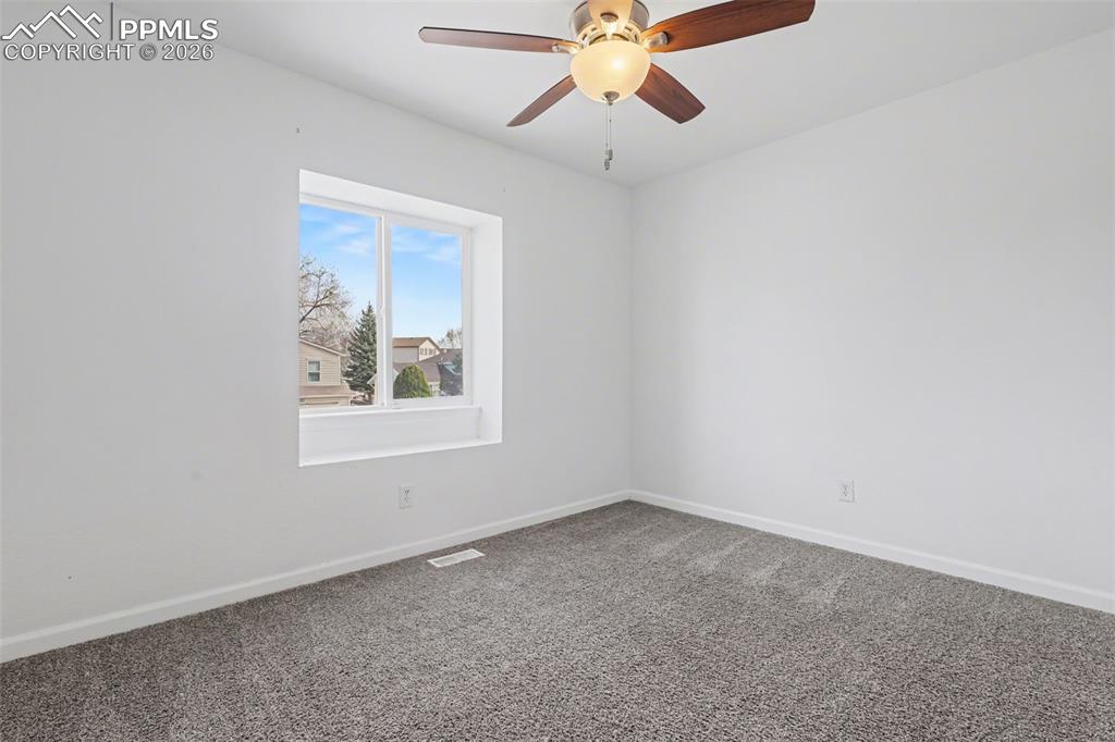 585 Blossom Field Road Fountain, CO 80817 - Photo 15 of 37 an empty room with a window and a fan