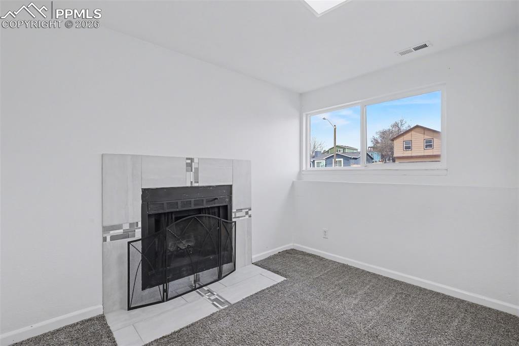 585 Blossom Field Road Fountain, CO 80817 - Photo 20 of 37 a living room with a fireplace