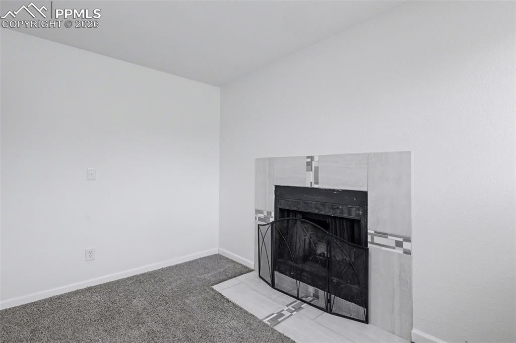 585 Blossom Field Road Fountain, CO 80817 - Photo 21 of 37 a room with a fireplace