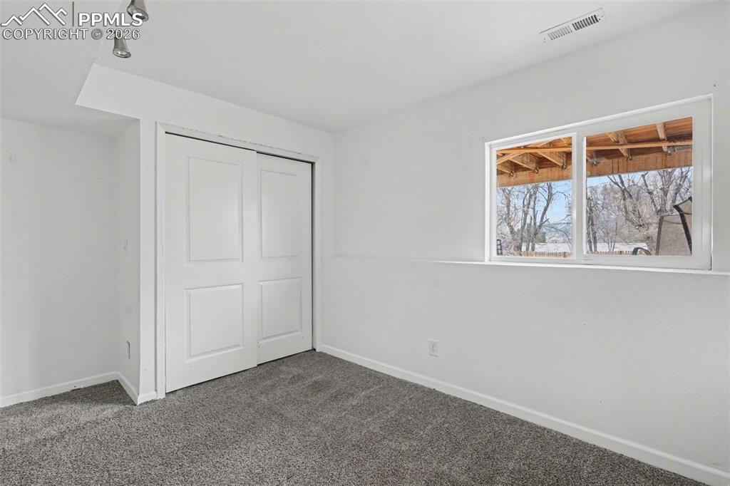 585 Blossom Field Road Fountain, CO 80817 - Photo 23 of 37 a view of an empty room with a window