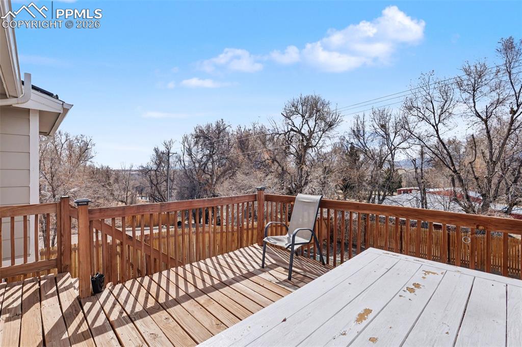 585 Blossom Field Road Fountain, CO 80817 - Photo 26 of 37 a view of balcony with wooden floor and outdoor seating