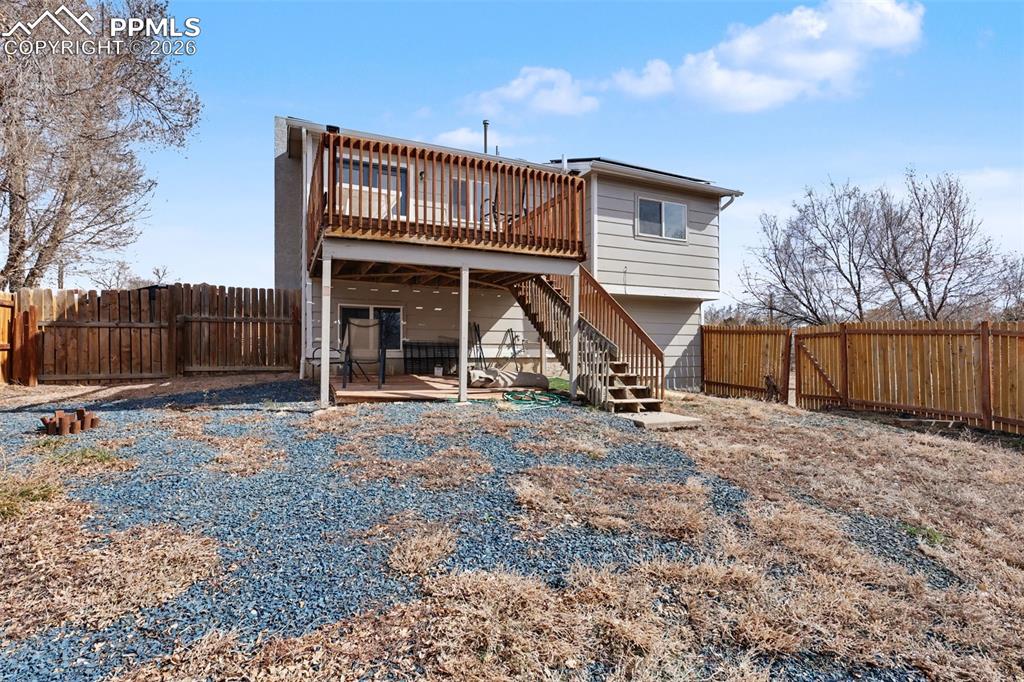 585 Blossom Field Road Fountain, CO 80817 - Photo 29 of 37 a view of a house with backyard and a tree