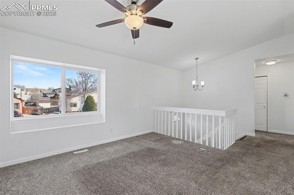 585 Blossom Field Road Fountain, CO 80817 - Photo 8 of 37 an empty room with windows and fan view