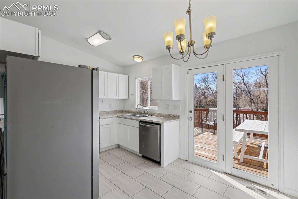 585 Blossom Field Road Fountain, CO 80817 - Photo 10 of 37 a kitchen with stainless steel appliances granite countertop a stove and a refrigerator