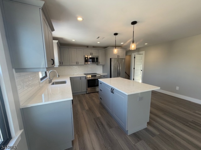 1122 East Boulevard, Unit A Alpha, NJ 08865 - Photo 5 of 15 a large kitchen with stainless steel appliances a large counter top a sink a stove and a refrigerator