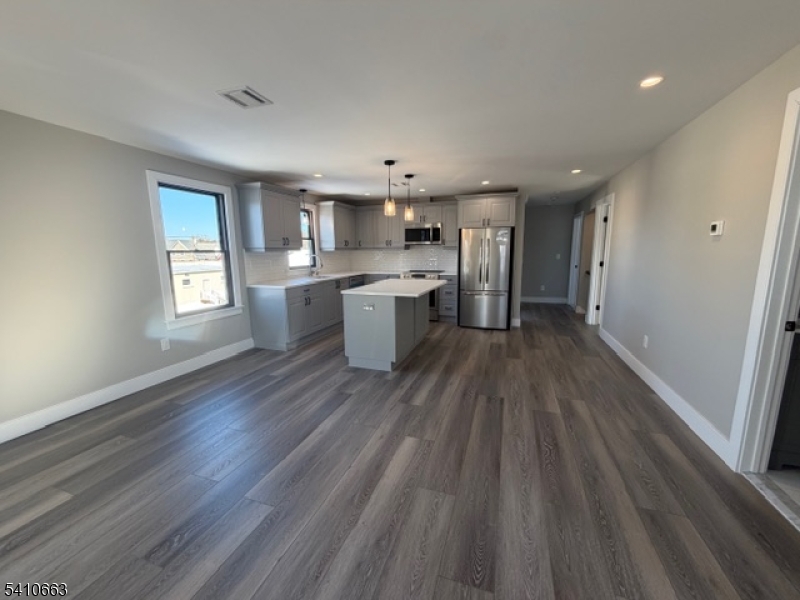 1122 East Boulevard, Unit A Alpha, NJ 08865 - Photo 9 of 15 a large kitchen with a wooden floor and stainless steel appliances