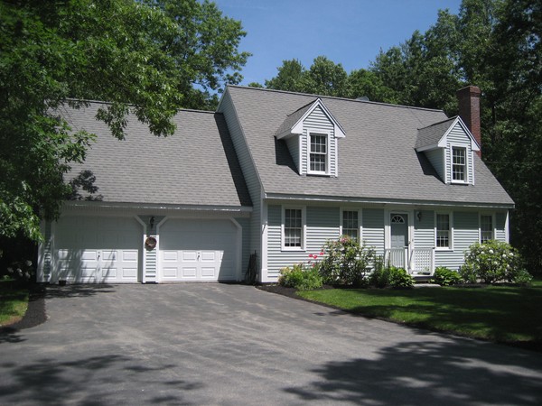 42 Peabody Road Shirley, MA 01464 - Photo 1 of 24 a view of a white house next to a yard with potted plants