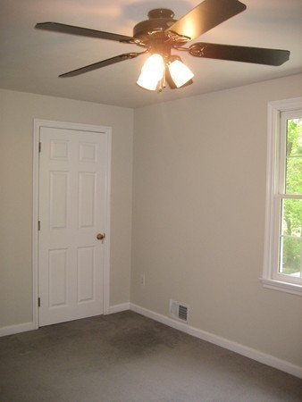 42 Peabody Road Shirley, MA 01464 - Photo 15 of 24 an empty room with a window and a chandelier fan