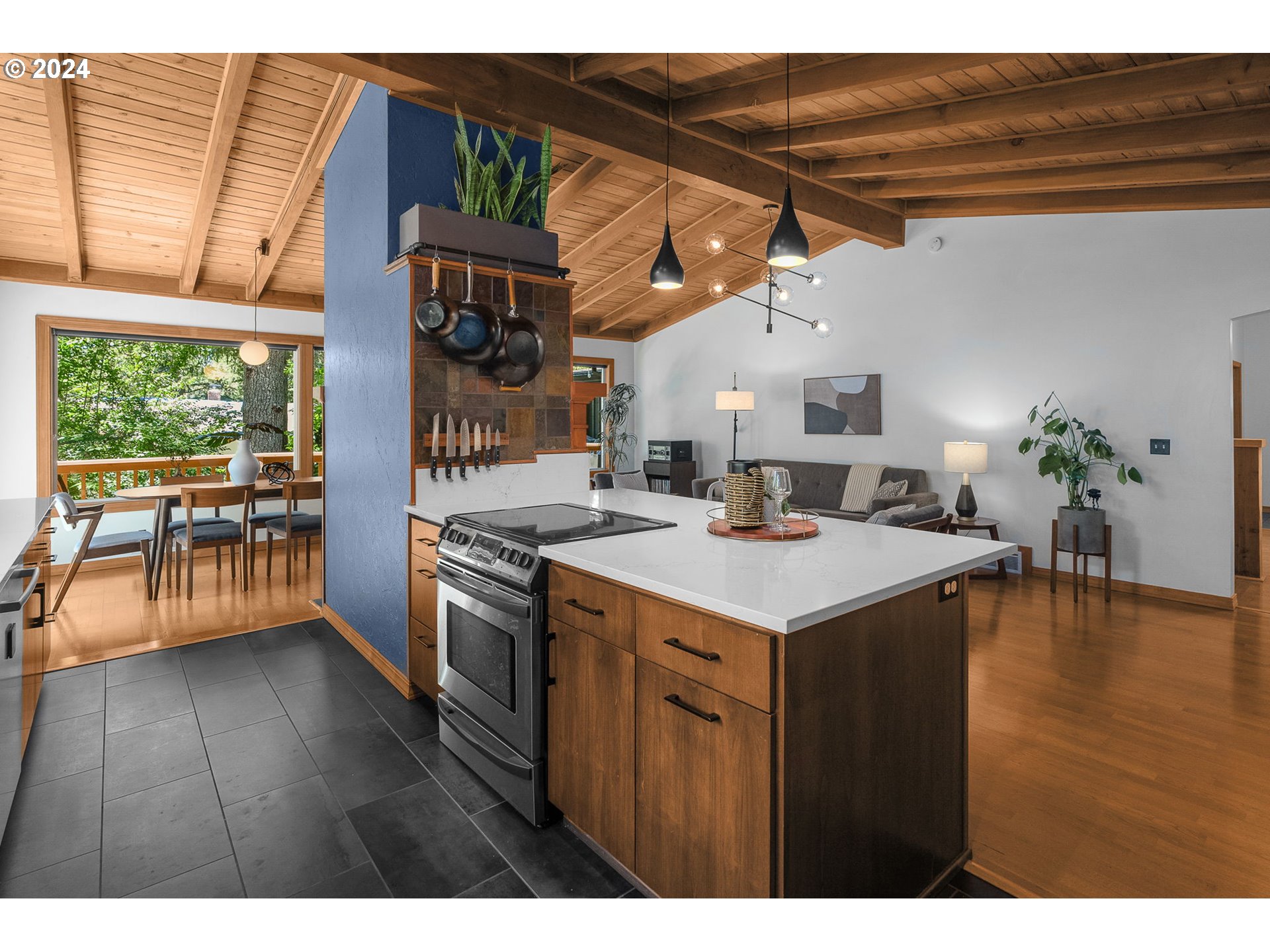 4215 Southwest Dosch Road Portland, OR 97239 - Photo 21 of 48 a kitchen that has a kitchen island wooden floor and a view of living room