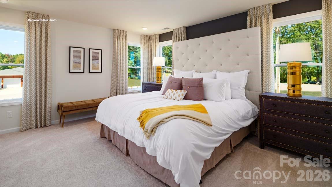 3111 Spring Iris Drive Denver, NC 28037 - Photo 22 of 44 a bed sitting in a bedroom next to a window