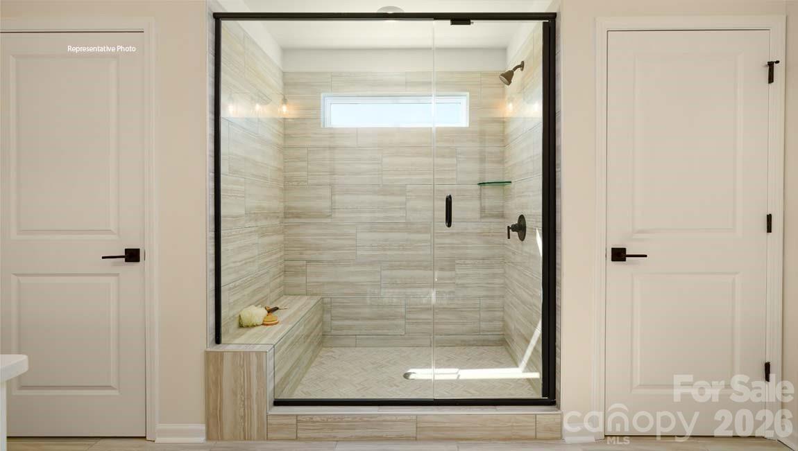 3111 Spring Iris Drive Denver, NC 28037 - Photo 29 of 44 a bathroom with a glass shower door
