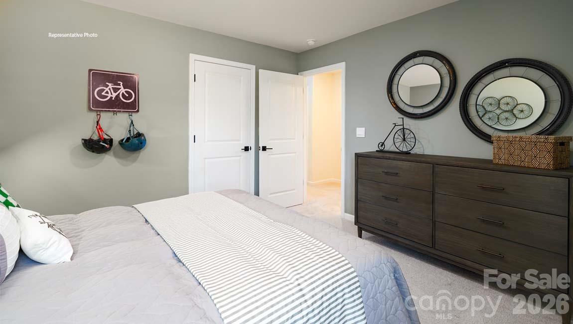 3111 Spring Iris Drive Denver, NC 28037 - Photo 33 of 44 a bedroom with a bed and a wall painting