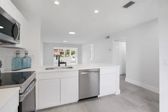 a kitchen with a sink and cabinets