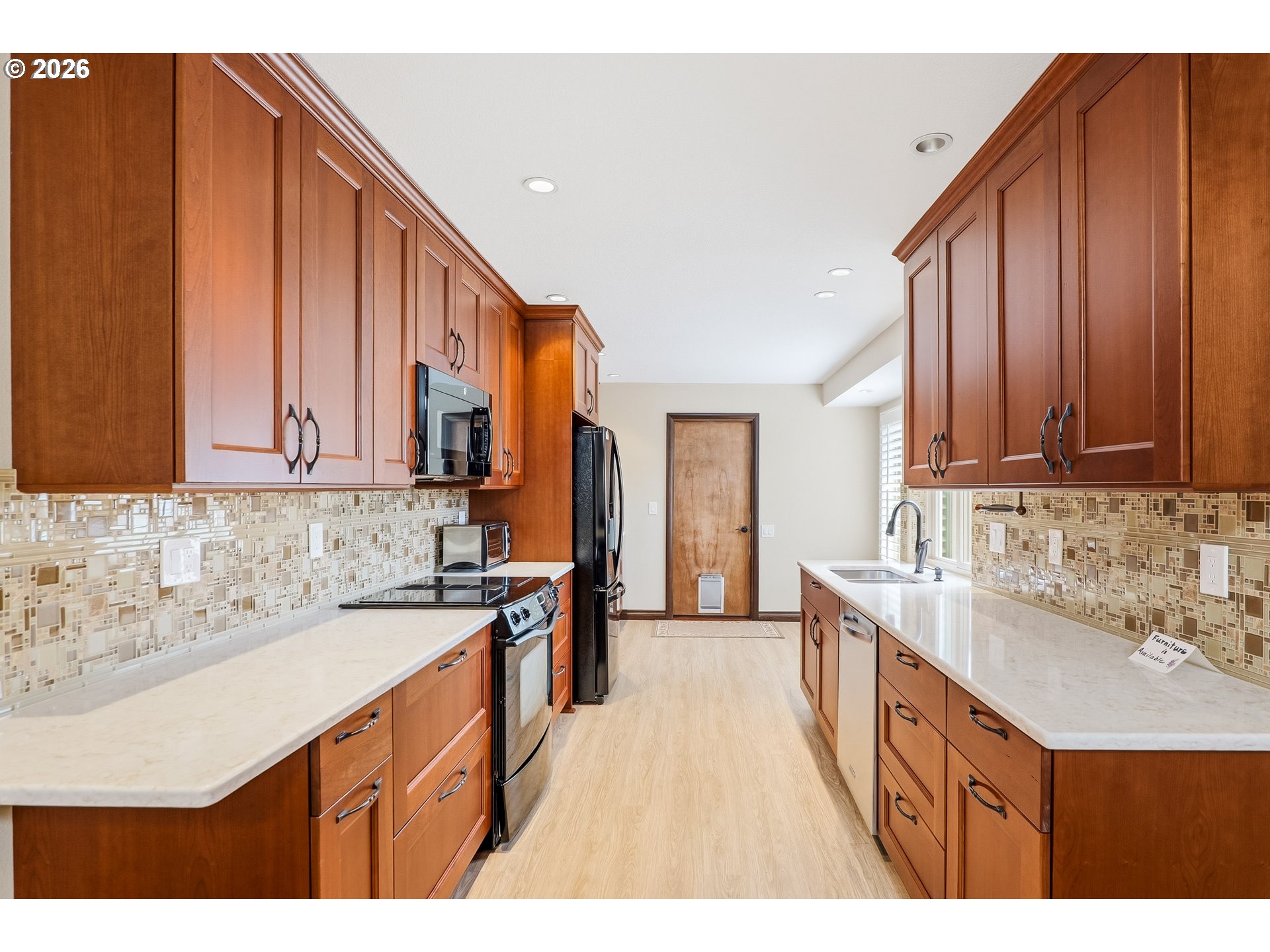 10290 Southwest Greenleaf Terrace Portland, OR 97224 - Photo 5 of 26 a kitchen with a sink and cabinets