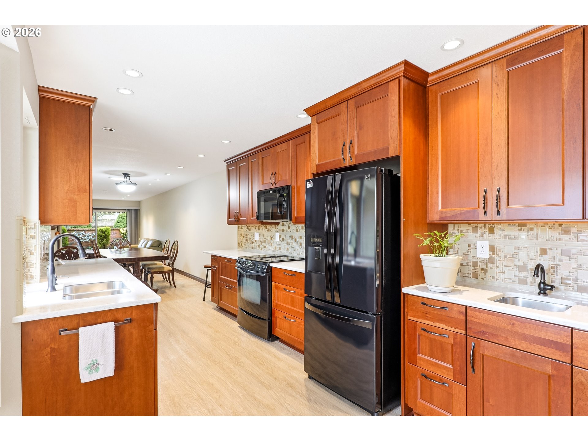 10290 Southwest Greenleaf Terrace Portland, OR 97224 - Photo 6 of 26 a kitchen with stainless steel appliances granite countertop a refrigerator stove and sink