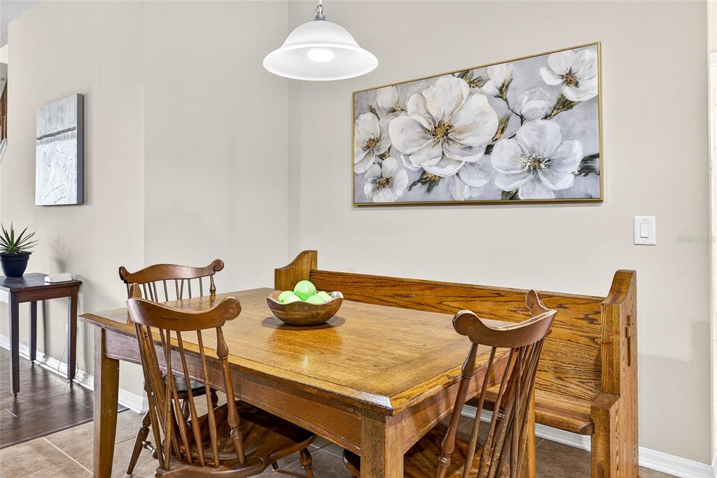 10859 Breaking Rocks Drive Tampa, FL 33647 - Photo 13 of 57 a view of a dining room with furniture and wooden floor