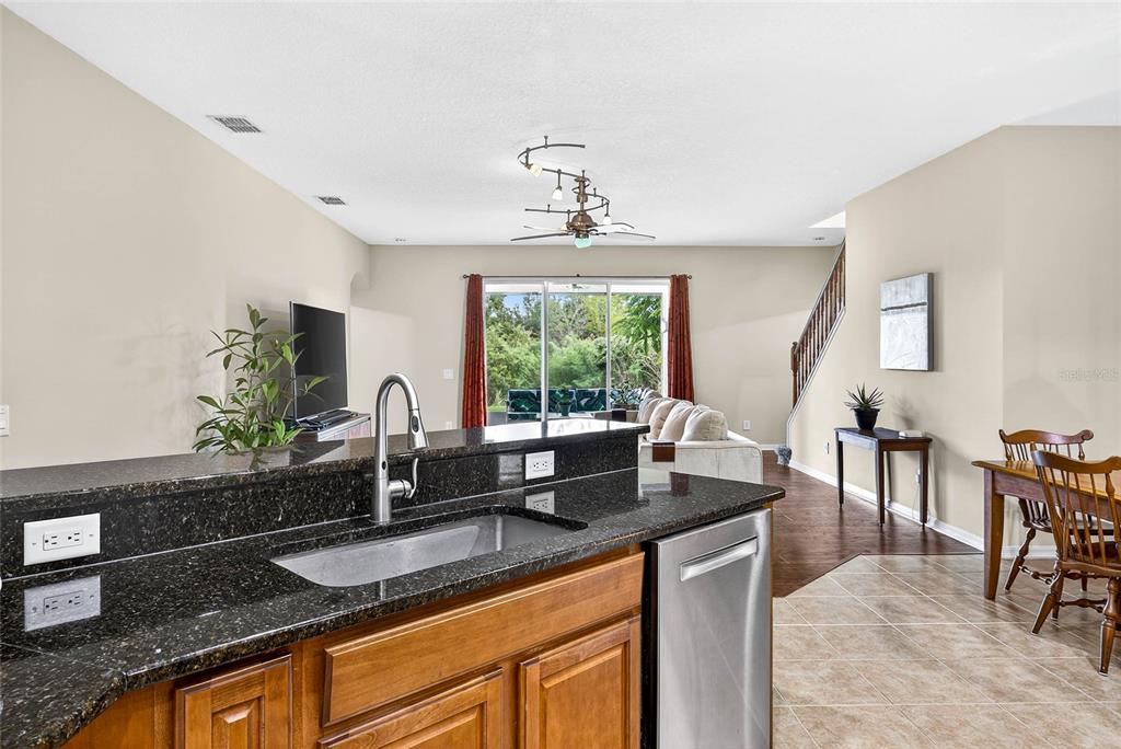 10859 Breaking Rocks Drive Tampa, FL 33647 - Photo 16 of 57 a kitchen with granite countertop a sink and a large window