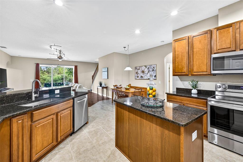 10859 Breaking Rocks Drive Tampa, FL 33647 - Photo 18 of 57 a kitchen with stainless steel appliances granite countertop a sink stove and cabinets