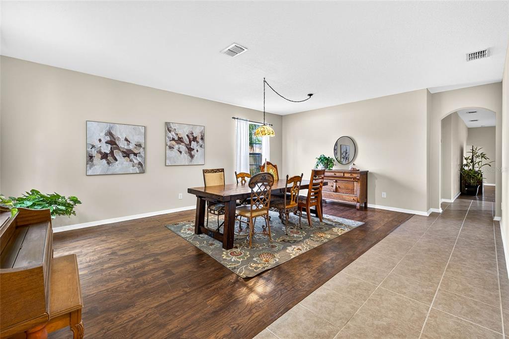 10859 Breaking Rocks Drive Tampa, FL 33647 - Photo 3 of 57 a view of a dining room with furniture and wooden floor