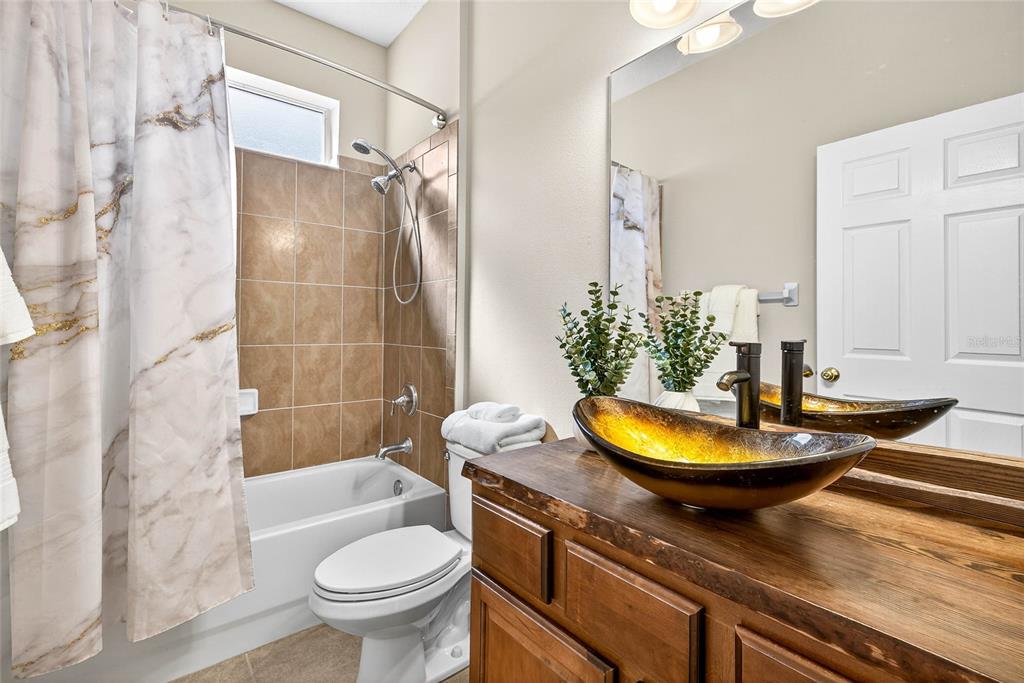 10859 Breaking Rocks Drive Tampa, FL 33647 - Photo 31 of 57 a bathroom with a granite countertop sink and a mirror