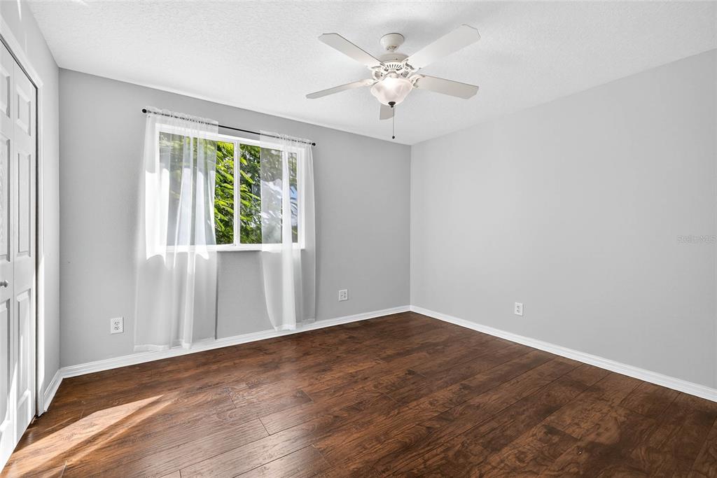 10859 Breaking Rocks Drive Tampa, FL 33647 - Photo 36 of 57 an empty room with wooden floor and windows