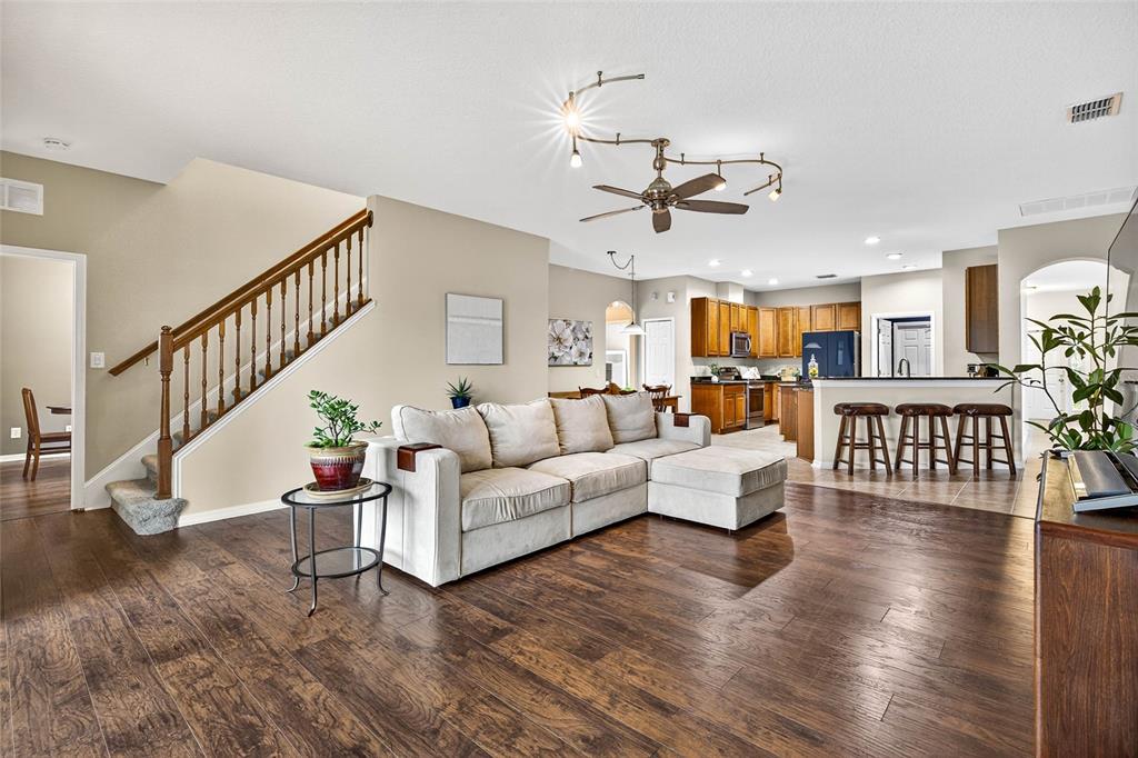 10859 Breaking Rocks Drive Tampa, FL 33647 - Photo 10 of 57 a living room with fireplace furniture and a wooden floor