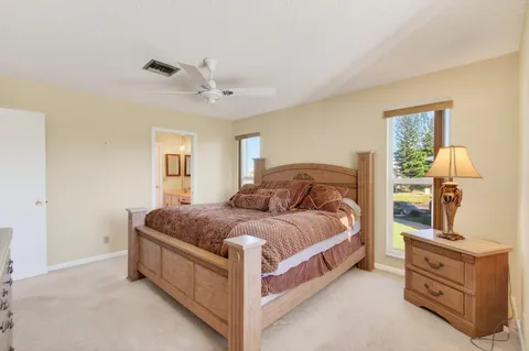 a spacious bedroom with a bed and dresser
