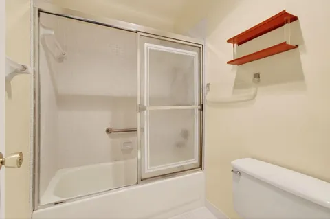 a bathroom with a shower and a toilet