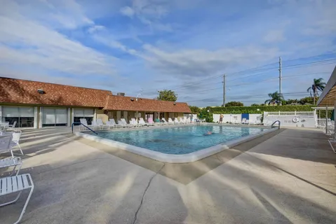 a view of a swimming pool with outdoor seating