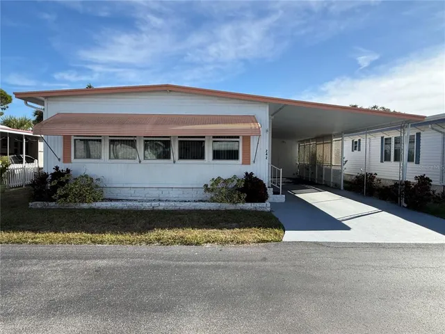 a front view of a house with yard and garage