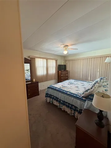 a spacious bedroom with a bed and window