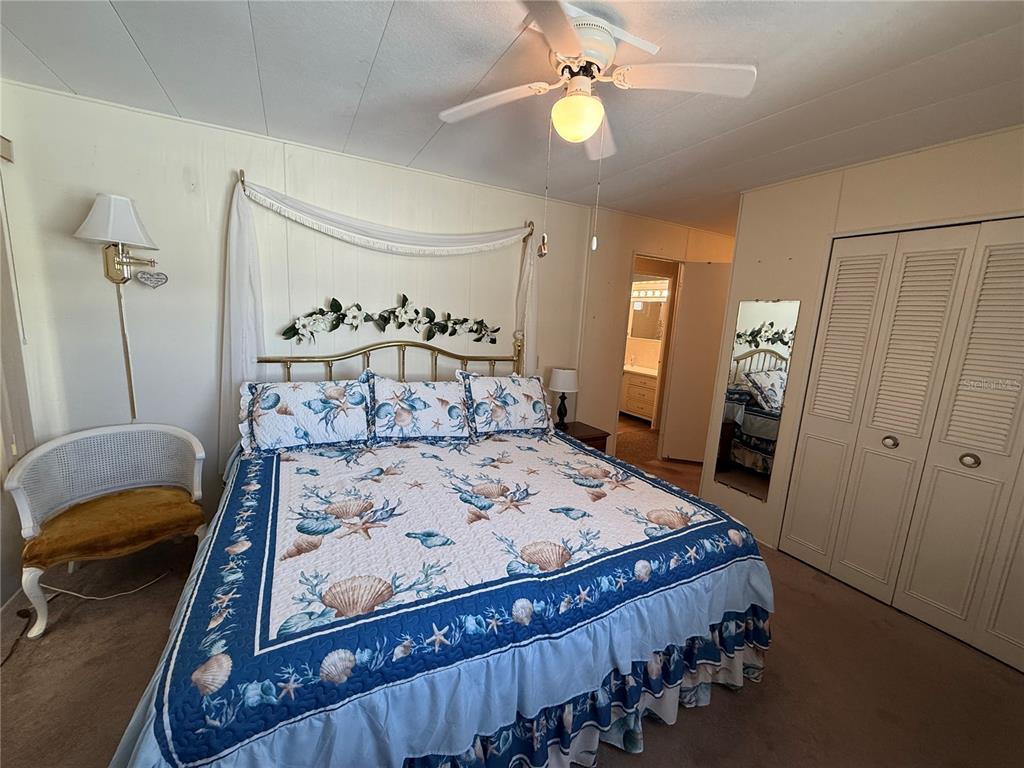 9900 Ulmerton Road, Unit 242 Largo, FL 33771 - Photo 12 of 21 a bed sitting in a bedroom next to a window