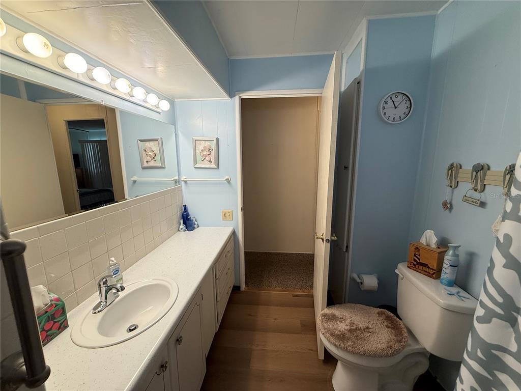 9900 Ulmerton Road, Unit 242 Largo, FL 33771 - Photo 14 of 21 a bathroom with a sink and a mirror