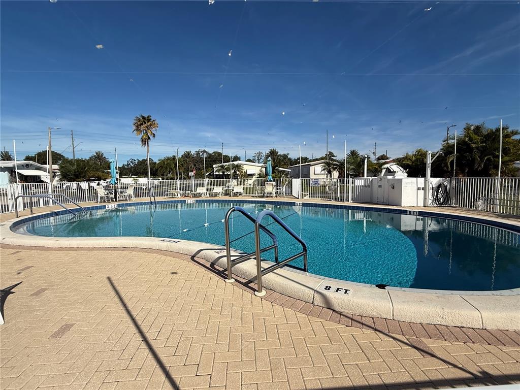 9900 Ulmerton Road, Unit 242 Largo, FL 33771 - Photo 19 of 21 a view of a swimming pool with a lounge chair
