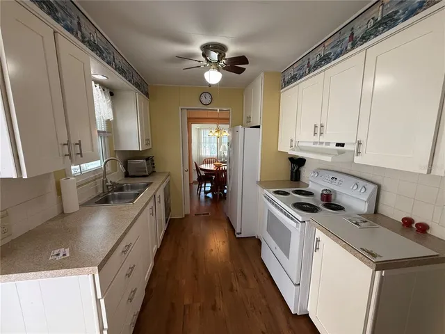 a kitchen with a stove a sink and a refrigerator
