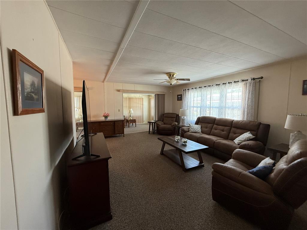 9900 Ulmerton Road, Unit 242 Largo, FL 33771 - Photo 6 of 21 a living room with furniture window and a refrigerator
