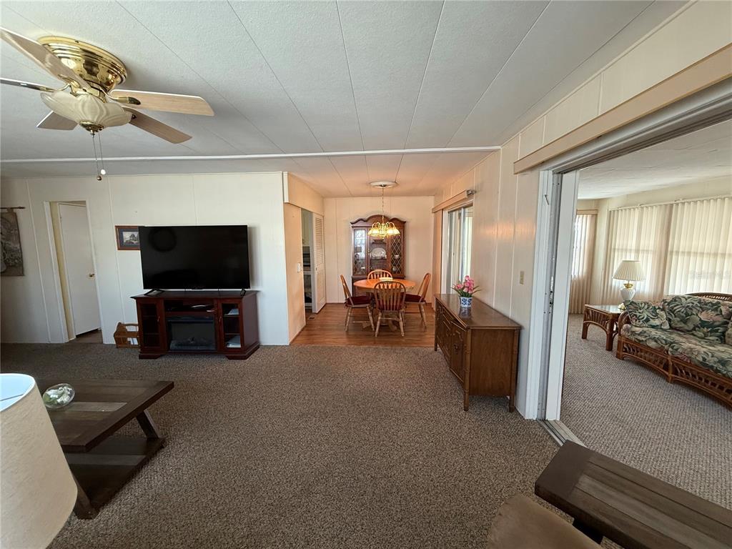 9900 Ulmerton Road, Unit 242 Largo, FL 33771 - Photo 7 of 21 a living room with furniture and a flat screen tv