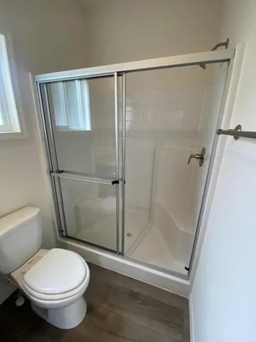 a bathroom with a toilet and a shower