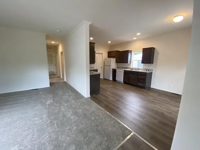 a view of living room with furniture and flat screen tv