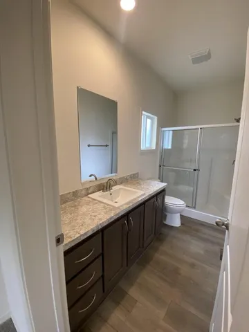 a bathroom with a granite countertop sink and mirror